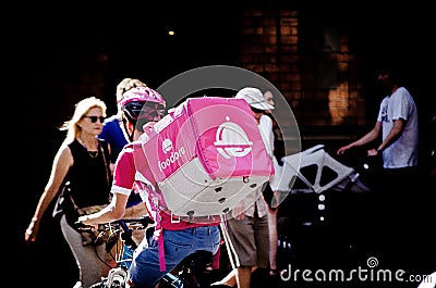 Foodora bicycle rider doing food delivery in downtown of Sydney. Editorial Stock Photo
